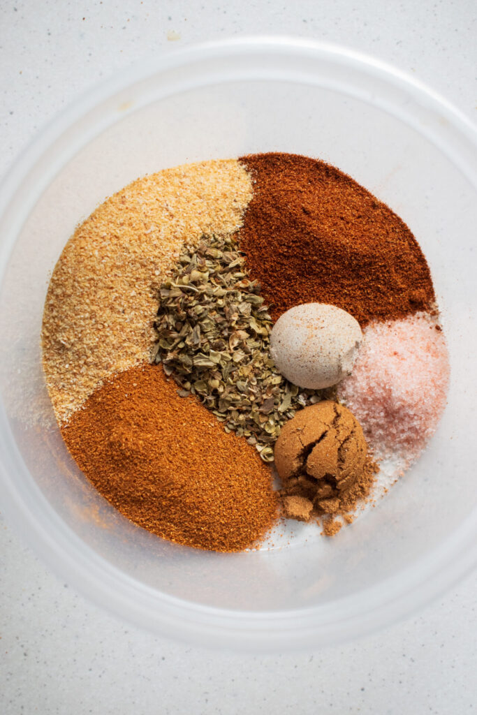 A dry rub mixture using garlic powder, origanum, paprika, cayenne pepper, mixed spice, white pepper and salt.